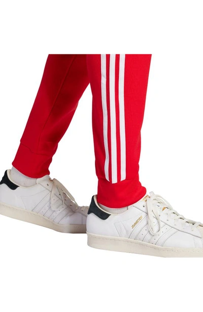 Shop Adidas Originals Lifestyle Superstar Joggers In Better Scarlet/ White