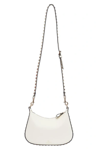 Shop Valentino Small Rockstud Leather Hobo Bag In 098 Ivory