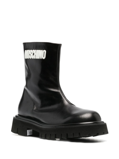 Shop Moschino Embossed-logo Zipped Leather Boots In Black