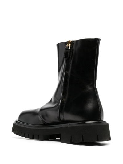 Shop Moschino Embossed-logo Zipped Leather Boots In Black