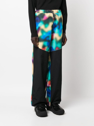 Shop Oamc Panelled Abstract-print Drawstring Trousers In Grün