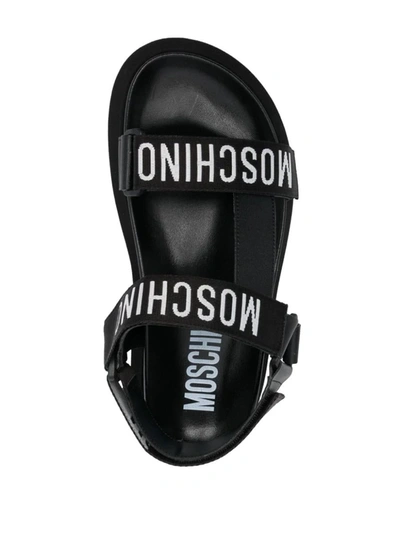 Shop Moschino Flat Sandals With Logo Strap In Black