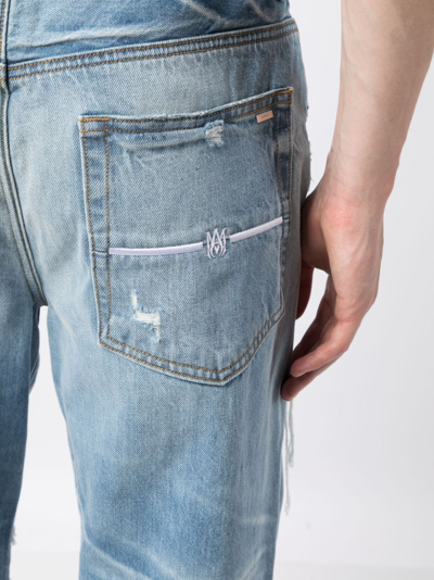 Shop Amiri Distressed Lose-fit Jeans In Blue
