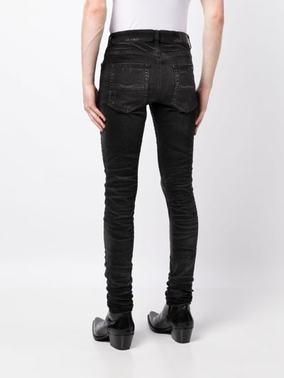 Shop Amiri Stack Whiskered Skinny Jeans In Black