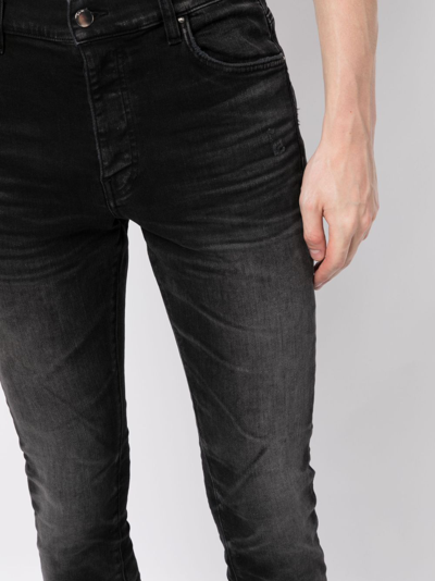 Shop Amiri Stack Whiskered Skinny Jeans In Black
