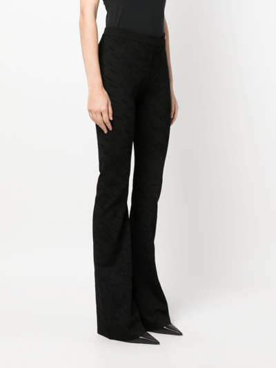 Shop Versace Greca-knit Flared Trousers In Black