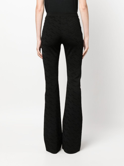 Shop Versace Greca-knit Flared Trousers In Black