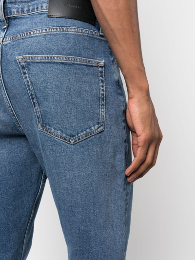 Shop Calvin Klein Logo-patch Mid-rise Tapered Jeans In Blue