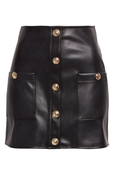 Shop L Agence Truman Snap Faux Leather Miniskirt In Black