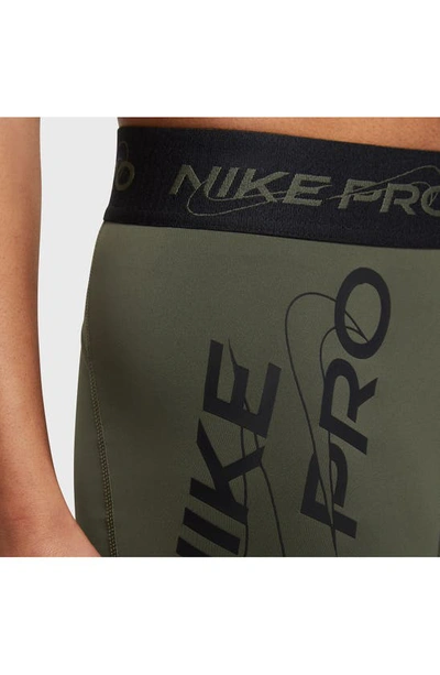 Shop Nike Pro Mid Rise Graphic Training Shorts In Cargo Khaki/ Black