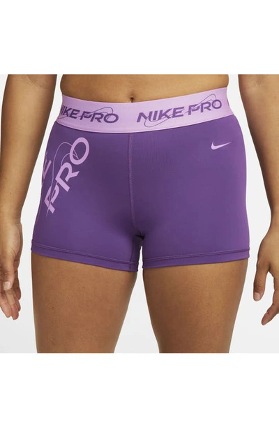 Shop Nike Pro Mid Rise Graphic Training Shorts In Purple Cosmos/ Rush Fuchsia