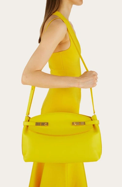 Shop Ferragamo Large Hug Pouch Bag In Yellow