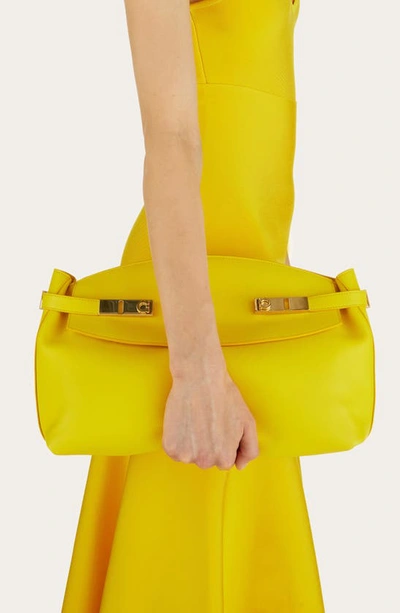 Shop Ferragamo Large Hug Pouch Bag In Yellow