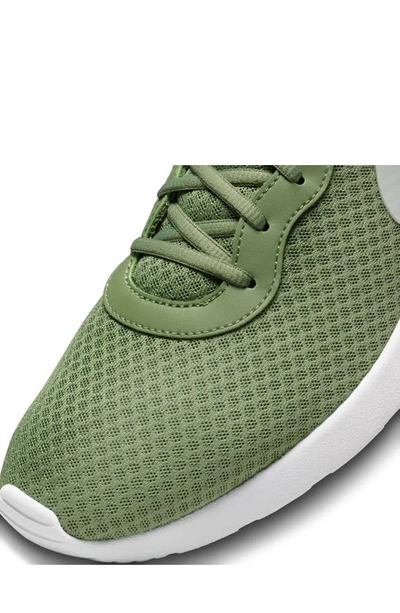Shop Nike Tanjun Flyease Shoe In Oil Green/ Light Silver/ White