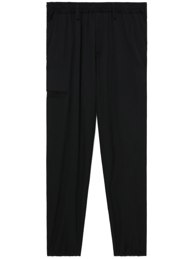 Shop Yohji Yamamoto Logo-patch Wool Trousers In Schwarz