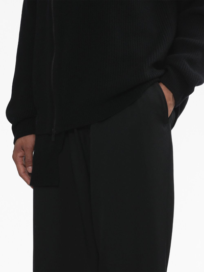 Shop Yohji Yamamoto Logo-patch Wool Trousers In Schwarz