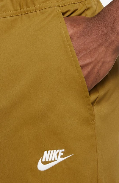 Shop Nike Woven Tapered Leg Pants In Bronze/ White