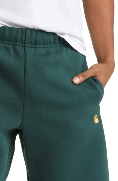 Shop Carhartt Chase Sweat Shorts In Discovery Green / Gold