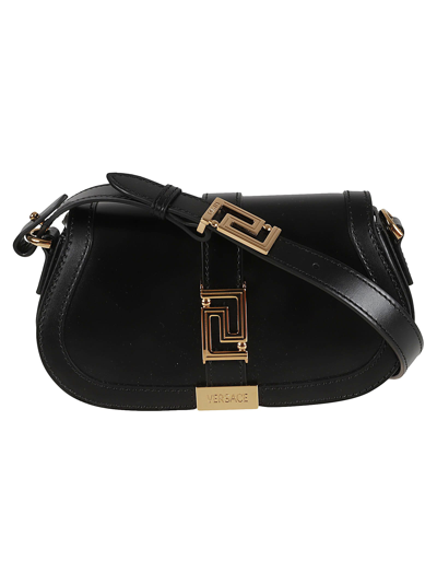 Shop Versace Logo Engraved Shoulder Bag In Black/gold