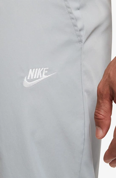 Shop Nike Woven Tapered Leg Pants In Light Smoke Grey/ White