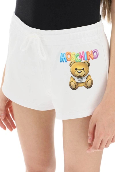 Shop Moschino Logo Printed Shorts In White
