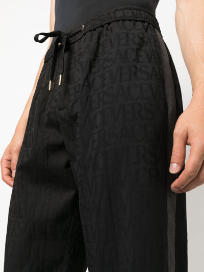 Shop Versace Allover Track Pants In Black