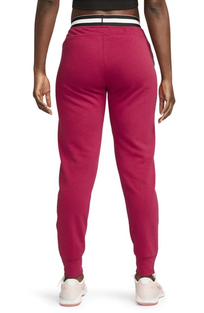 Shop Nike Court Dri-fit Heritage Fleece Pants In Noble Red