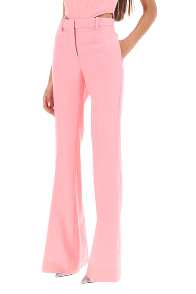 Shop Versace Low Waisted Flared Trousers In Pastel Pink (pink)