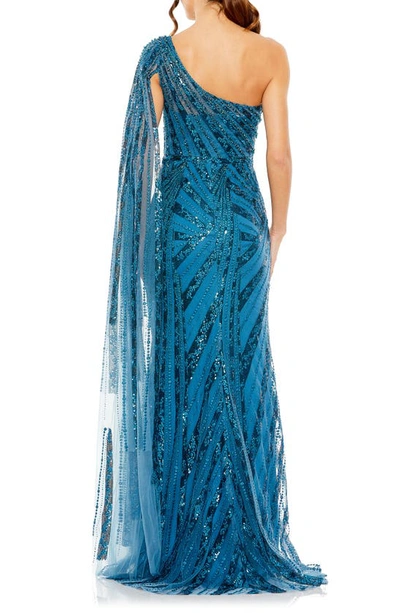 Shop Mac Duggal Sequin Cape Sleeve One-shoulder Gown In Ocean Blue