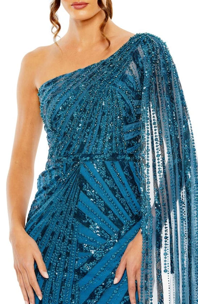 Shop Mac Duggal Sequin Cape Sleeve One-shoulder Gown In Ocean Blue