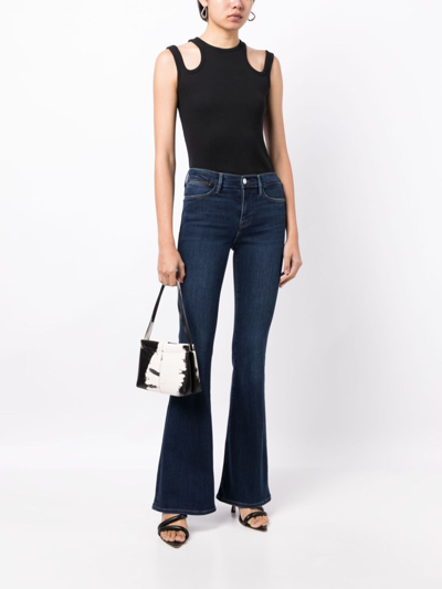 Shop Frame Mid-rise Flared Jeans In Blue