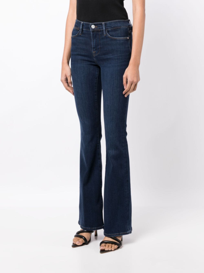 Shop Frame Mid-rise Flared Jeans In Blue