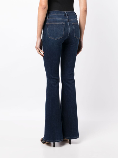 Shop Frame Mid-rise Flared Jeans In Blue