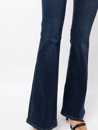 Shop Frame Mid-rise Flared Jeans In Blue