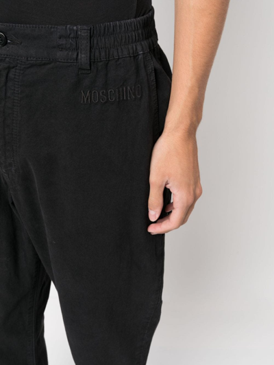 Shop Moschino Logo-embroidered Straight-leg Trousers In Schwarz