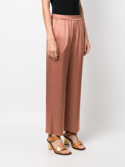 Shop Nanushka Elasticated-waist Cropped Trousers In Orange