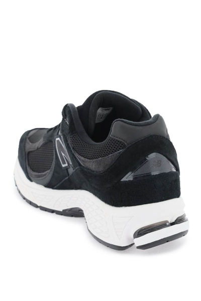Shop New Balance 2002r Sneakers In Black (black)