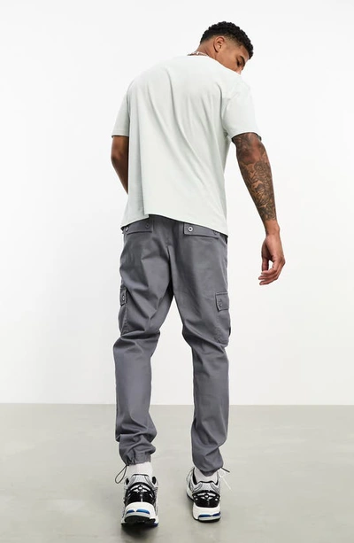 Shop Asos Design Tapered Cargo Pants In Dark Grey