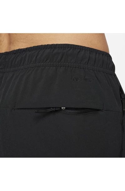 Shop Nike Dri-fit Unlimited Drawstring Pants In Black/ Black/ Black