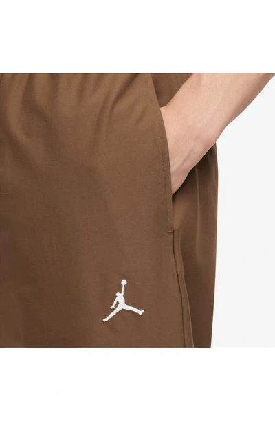 Shop Jordan Essentials Stretch Crop Pants In Light British Tan/ White