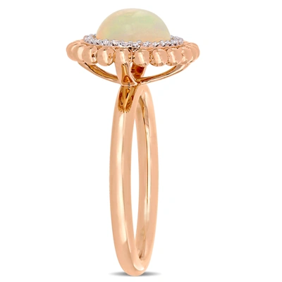 Mimi & Max 2 3/4 Ct Tgw Oval-cut Ethiopian Blue-hued Opal And 1/10 Ct Tw Diamond Halo Ring In 14k Rose Gold In Pink
