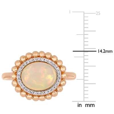 Mimi & Max 2 3/4 Ct Tgw Oval-cut Ethiopian Blue-hued Opal And 1/10 Ct Tw Diamond Halo Ring In 14k Rose Gold In Pink