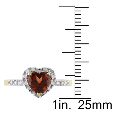 Mimi & Max Halo Heart Shaped Garnet Ring With 1/10 Ct Tw Diamonds In 10k Yellow Gold In Red