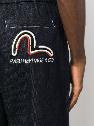 Shop Evisu Seagull-print Tapered Jeans In Blue