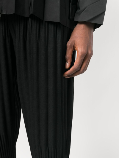 Shop Issey Miyake Pleated Tapered Cropped Trousers In Black