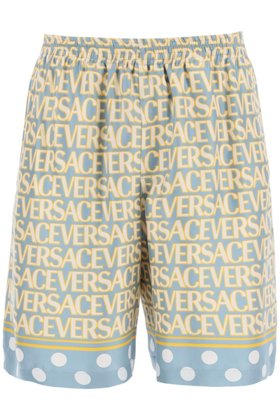Versace Silk Bermuda Shorts With All-over Logo In Light Blue,yellow,white