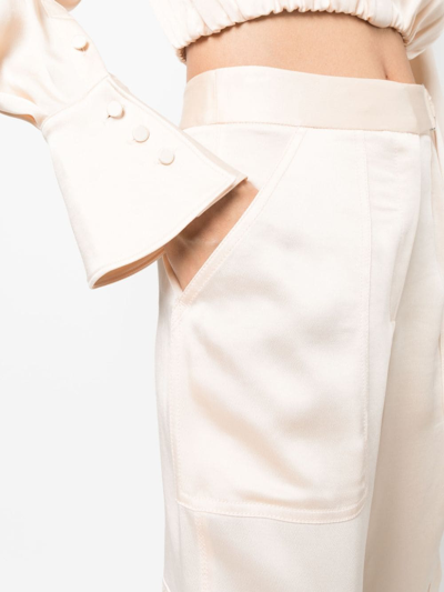 Shop Simkhai Satin-finish Cropped Trousers In Nude