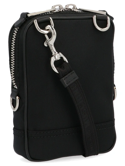 Shop Moschino Label Crossbody Bags In Black