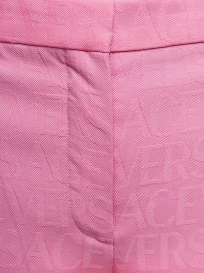 Shop Versace Pink Flare Pants With Tonal Logo Lettering In Wool Woman