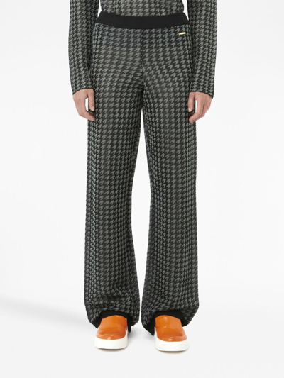 Shop Jw Anderson Check-pattern Logo-plaque Trousers In Schwarz